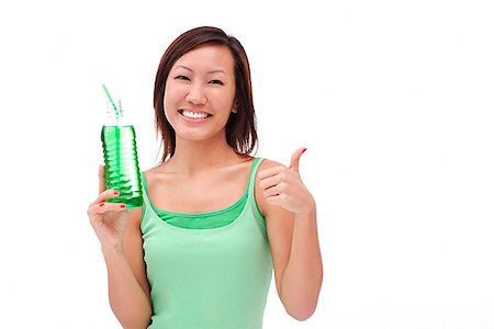 Young woman holding bottled drink making thumbs up sign Stock Photo - Premium Royalty-Free, Code: 656-01773195