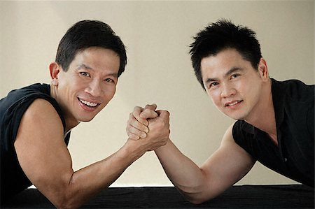 fitness asian couple - Two men ready to arm wrestle Stock Photo - Premium Royalty-Free, Code: 656-02371747