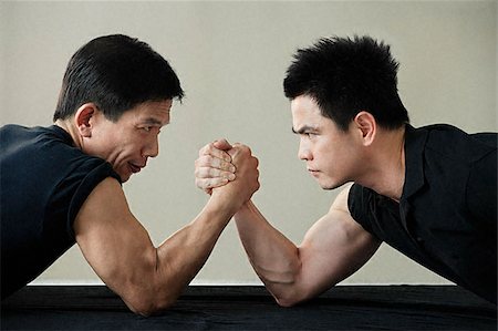 fitness asian couple - Two men locked in arm wrestling Stock Photo - Premium Royalty-Free, Code: 656-02371743