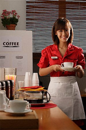 Waitress in diner holding coffee Stock Photo - Premium Royalty-Free, Code: 656-02371866