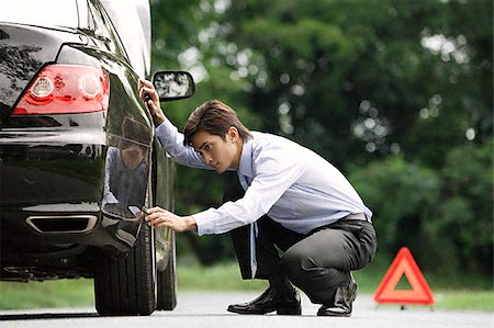 frustrated boss - Man inspecting car Stock Photo - Premium Royalty-Free, Code: 656-02371874