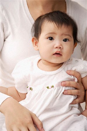 filipino dress - Baby girl being held on woman's lap Stock Photo - Premium Royalty-Free, Code: 656-02660243