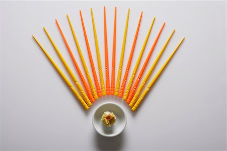 Orange and yellow chopsticks lined up over dim sum. Stock Photo - Premium Royalty-Free, Code: 656-03076225