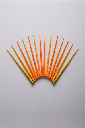 Orange and yellow chopsticks in the shape of a fan. Stock Photo - Premium Royalty-Free, Code: 656-03076247