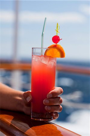 ships at sea - A woman holding a fruit cocktail Stock Photo - Premium Royalty-Free, Code: 659-06154124