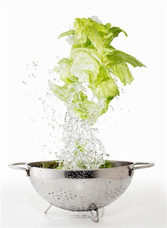 simsearch:659-06154334,k - Iceberg lettuce being washed in a colander Stock Photo - Premium Royalty-Free, Code: 659-06154329