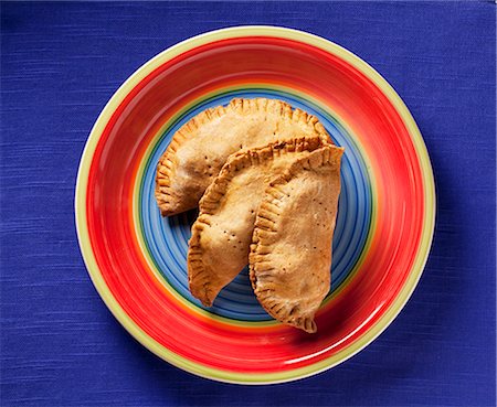 photography jamaica - Beef Filled Pastries on a Colorful Plate; From Above Stock Photo - Premium Royalty-Free, Code: 659-06154901