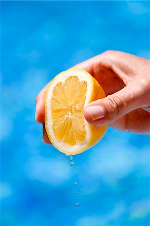 single lemon - A hand squeezing a lemon Stock Photo - Premium Royalty-Free, Code: 659-06155468