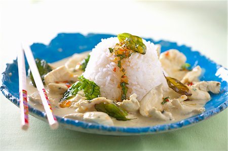 Chicken ragout with chilli sauce, fried basil and rice (Thailand) Stock Photo - Premium Royalty-Free, Code: 659-06151348