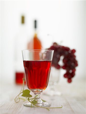 simsearch:659-06186663,k - A glass of red wine, red grapes and bottles of red wine Stock Photo - Premium Royalty-Free, Code: 659-06151589