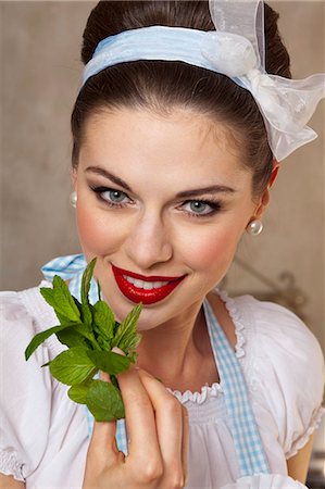 A retro-style girl holding fresh mint leaves Stock Photo - Premium Royalty-Free, Code: 659-06151769