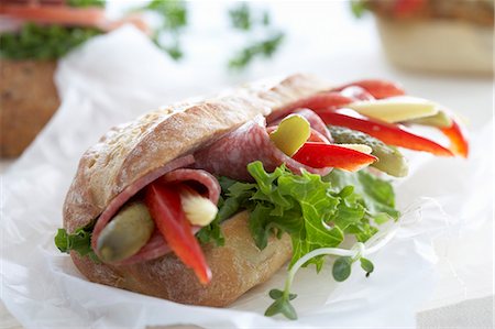 Ciabatta with salami, pepper, gherkins and baby corn cobs Stock Photo - Premium Royalty-Free, Code: 659-06151974