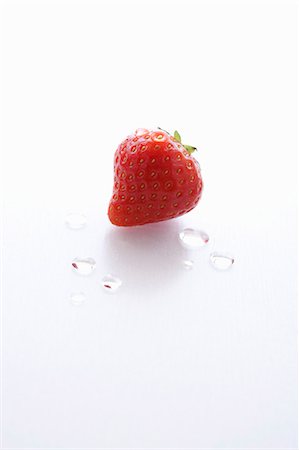single strawberry - A Single Wet Strawberry on a White Background Stock Photo - Premium Royalty-Free, Code: 659-06152228