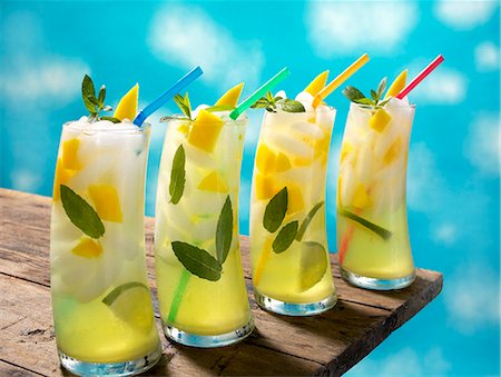 fruits in wooden table - Four Mango Lime Mojitos with Straws on a Table Stock Photo - Premium Royalty-Free, Code: 659-06152847
