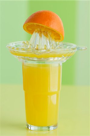 simsearch:659-06495307,k - A glass of orange juice, a juicer and an orange half Stock Photo - Premium Royalty-Free, Code: 659-06152915