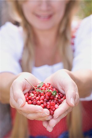 A woman holding lingonberries Stock Photo - Premium Royalty-Free, Code: 659-06153012