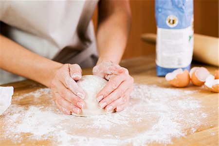 Woman Preparing Dough on a Floured Surface in Kitchen Stock Photo - Premium Royalty-Free, Code: 659-06153460