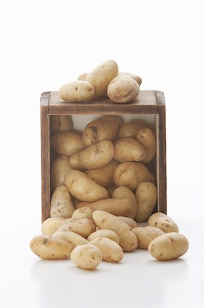 release - Fingerling Potatoes Spilling from a Crate; White Background Stock Photo - Premium Royalty-Free, Code: 659-06153470