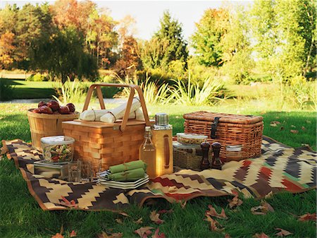 picnic basket - A picnic blanket and picnic baskets on a field Stock Photo - Premium Royalty-Free, Code: 659-06153494