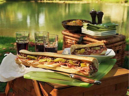 picnic basket - Picnic at the lake with Muffuletta (round Sicilian sesame bread) sandwiches Stock Photo - Premium Royalty-Free, Code: 659-06153493