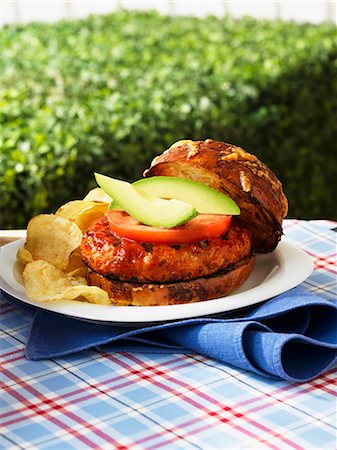 Chicken burger with tomatoes, avocados and potato chips Stock Photo - Premium Royalty-Free, Code: 659-06153532