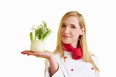 Blond female chef balancing fennel bulb on her hand Stock Photo - Premium Royalty-Free, Code: 659-06185446