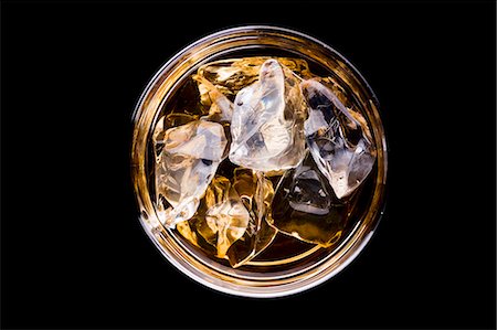 A glass of whiskey with ice cubes (seen from above) Stock Photo - Premium Royalty-Free, Code: 659-06185747