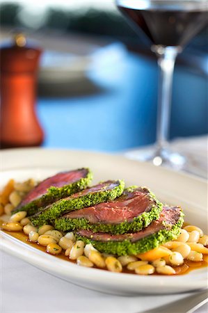 simsearch:659-06186142,k - Sliced Herb Crusted Lamb Served Over White Beans Stock Photo - Premium Royalty-Free, Code: 659-06186445