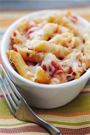 Individual Baked Penne with Tomatoes and Cheese; Fork Stock Photo - Premium Royalty-Free, Code: 659-06186508