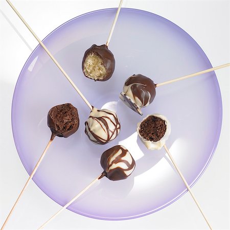 Cake pops with chocolate icing, one with a bite taken out Stock Photo - Premium Royalty-Free, Code: 659-06186744