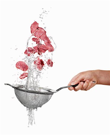 Pork being washed in a sieve Stock Photo - Premium Royalty-Free, Code: 659-06187098