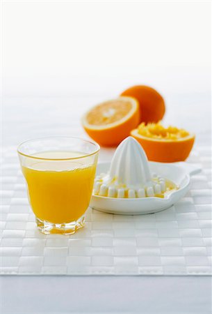 simsearch:659-06495307,k - A glass of orange juice, citrus squeezer and oranges Stock Photo - Premium Royalty-Free, Code: 659-06187335