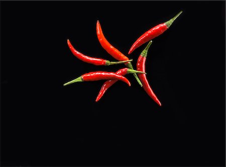 Red chillies on a black background Stock Photo - Premium Royalty-Free, Code: 659-06187546