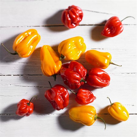 simsearch:659-07029044,k - Red and yellow mini peppers on a white wood surface (top view) Stock Photo - Premium Royalty-Free, Code: 659-06188042