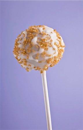 A cake pop with golden sprinkles Stock Photo - Premium Royalty-Free, Code: 659-06188323