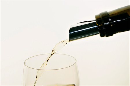 pourer - White Wine Pouring from Bottle into Glass; White Background Stock Photo - Premium Royalty-Free, Code: 659-06183715