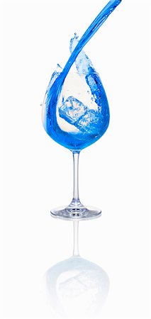 simsearch:659-01850296,k - A blue cocktail being poured into a glass with ice cubes Stock Photo - Premium Royalty-Free, Code: 659-06306554