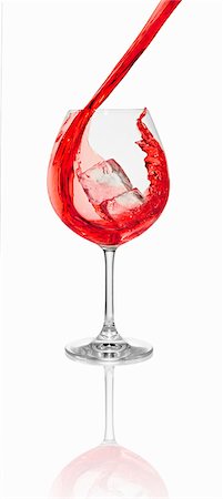 simsearch:659-01850296,k - A red cocktail being poured into a glass with an ice cube Stock Photo - Premium Royalty-Free, Code: 659-06306564