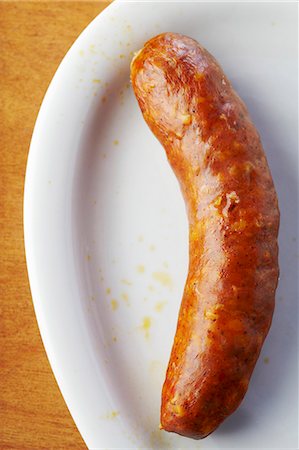 Spicy Polish Hot Dog on a White Dish Stock Photo - Premium Royalty-Free, Code: 659-06307195