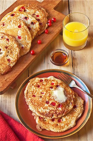 pancake - Cranberry Pancakes on a Plate and Cutting Board; Glass of Orange Juice and Maple Syrup Stock Photo - Premium Royalty-Free, Code: 659-06307241
