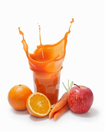 A splash of multi-vitamin juice surrounded by fruit Stock Photo - Premium Royalty-Free, Code: 659-06373008