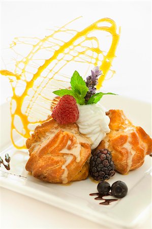 simsearch:659-06188604,k - Profiteroles au Chocolat; Chocolate Gonache Filled Cream Puff with Whipped Cream and Caramel Angel Hair Stock Photo - Premium Royalty-Free, Code: 659-06373239
