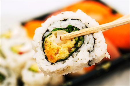 Chopsticks holding maki sushi Stock Photo - Premium Royalty-Free, Code: 659-06373382