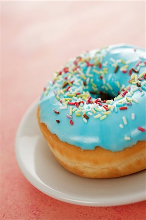 sprinkles - A blue-glazed doughnut decorated with sugar sprinkles Stock Photo - Premium Royalty-Free, Code: 659-06373519