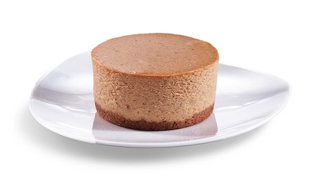 Mini Pumpkin Cheesecake on a White Plate; White Background Stock Photo - Premium Royalty-Free, Code: 659-06494111