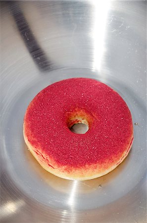 A doughnut dusted with cassis poweder Stock Photo - Premium Royalty-Free, Code: 659-06494424