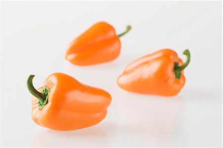 simsearch:659-06154334,k - Three orange peppers Stock Photo - Premium Royalty-Free, Code: 659-06495286