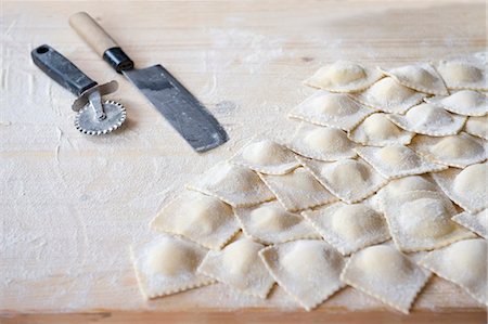 Fresh, homemade ravioli on a floured work surface Stock Photo - Premium Royalty-Free, Code: 659-06495396