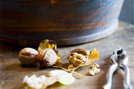 Whole and cracked walnuts with a nutcracker Stock Photo - Premium Royalty-Free, Code: 659-06495496