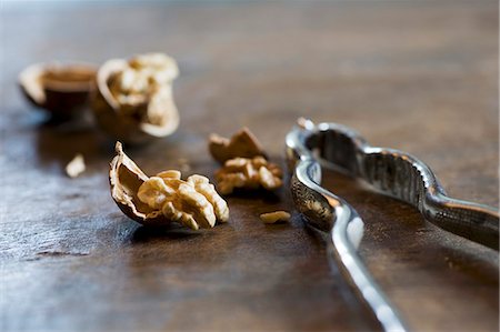 Cracked walnuts and a nutcracker Stock Photo - Premium Royalty-Free, Code: 659-06495492